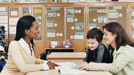 Teacher sitting with mother and her student