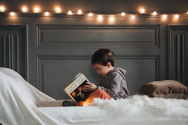 Child reading book in a reading list