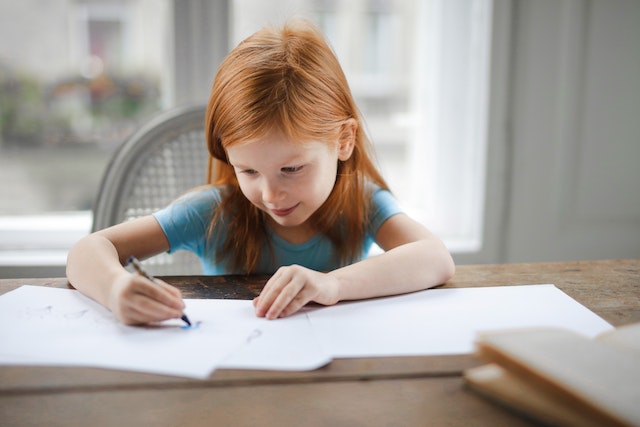 Child doing homeschool worksheet