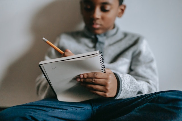 Child taking notes during homeschooling