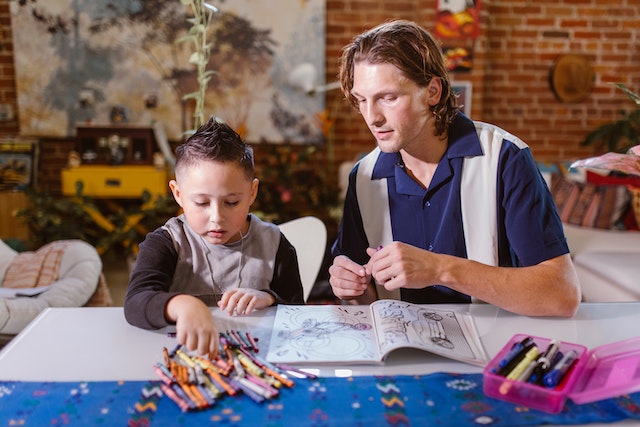 Father and child completing homeschooling project