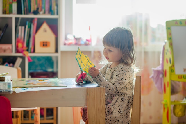 Preschooler performing crafts project