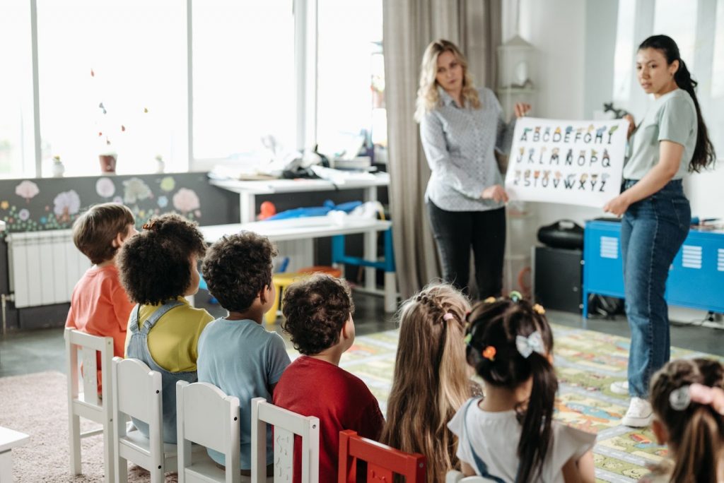 Children Sitting on Stools in Kindergarten Children Sitting on Stools in Kindergarten