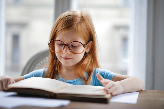 Preschooler reading through booklet