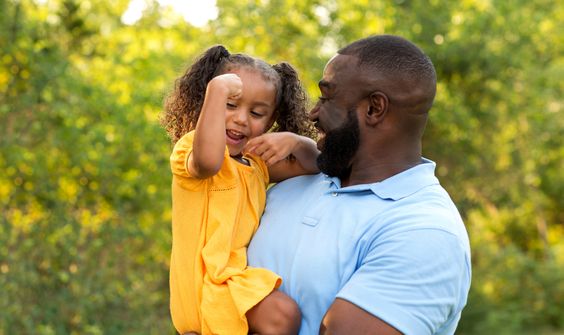 Daughter with her father showing strength