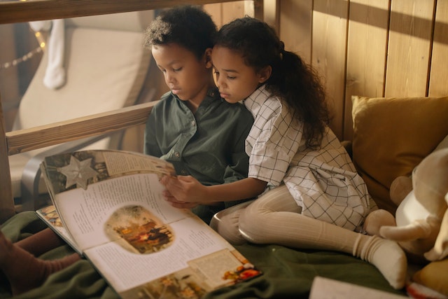 Kids reading book together