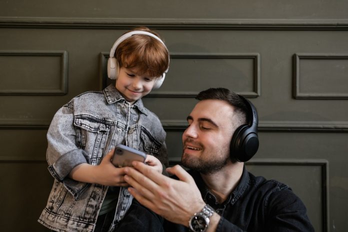 Father and son listening to podcast
