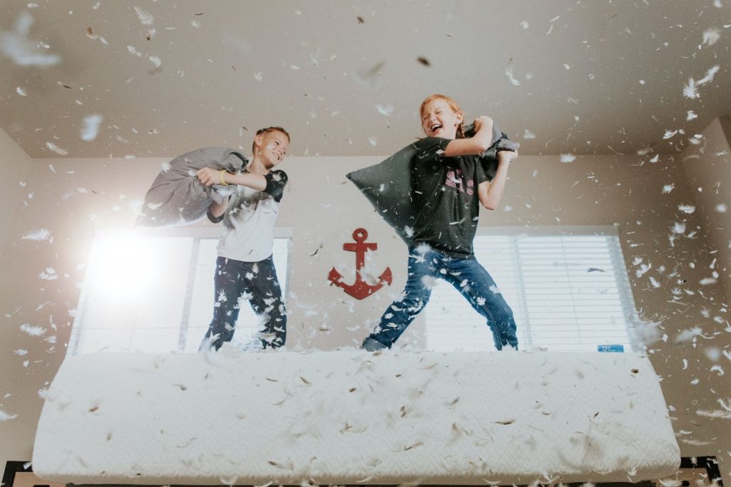 Siblings having a pillow fight