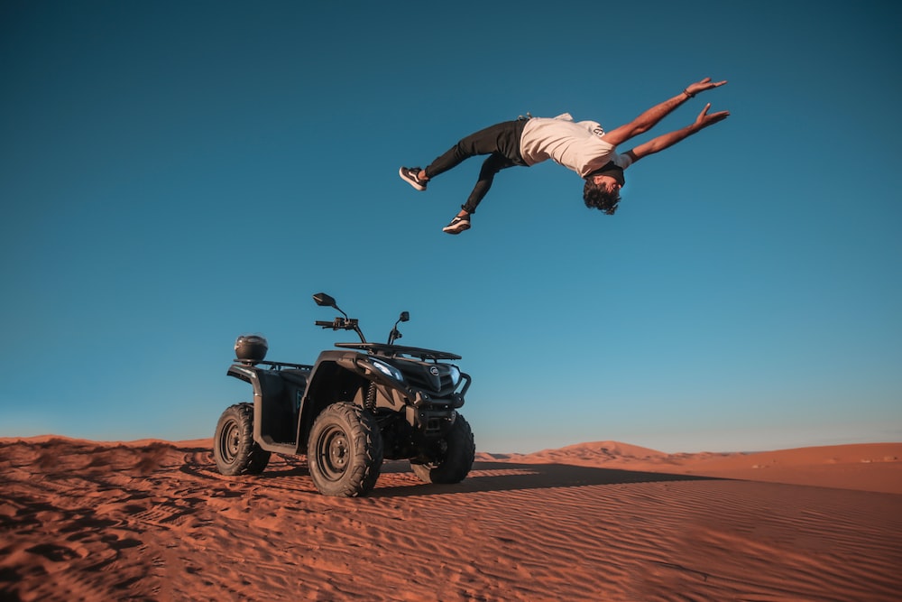 Teenager jumping from a 4X4 offroad