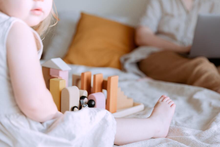 A little girl playing with wooden blocks