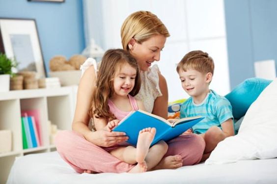 A mother reading a book to her kids
