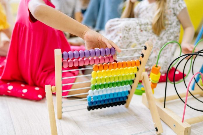Girl Holding Multi-Colored Wooden Abacus