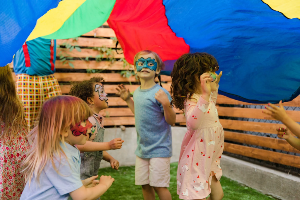 A group of kids with face paint play outside