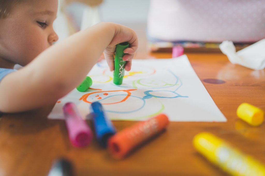 Little boy drawing on paper