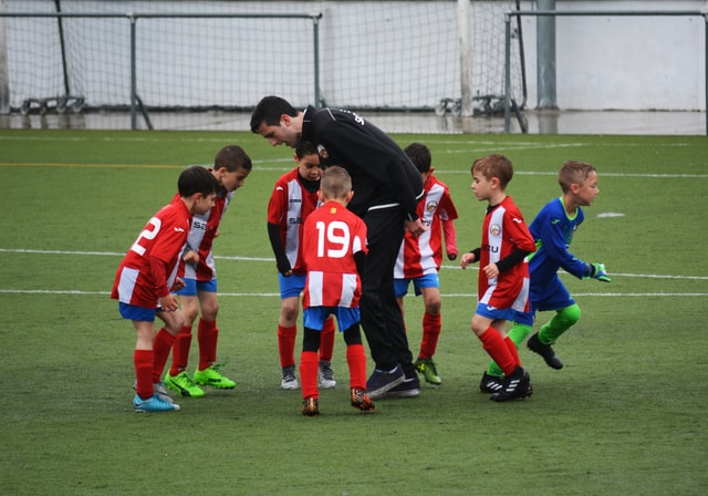 Kids playing with sports teacher