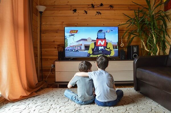 Two boys watching a Youtube video on TV