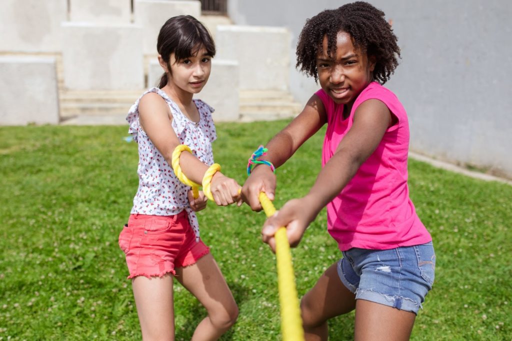 Two girls playing tug of war