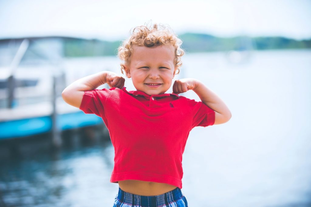 Kid standing near a lake