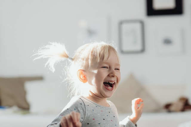 Kid laughing at summer jokes