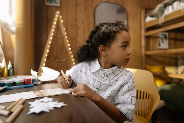 Child writing about her favorite day