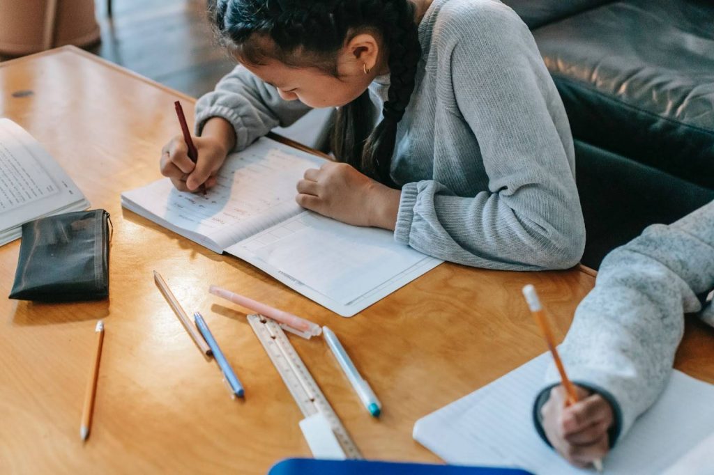 Kids writing in their copies