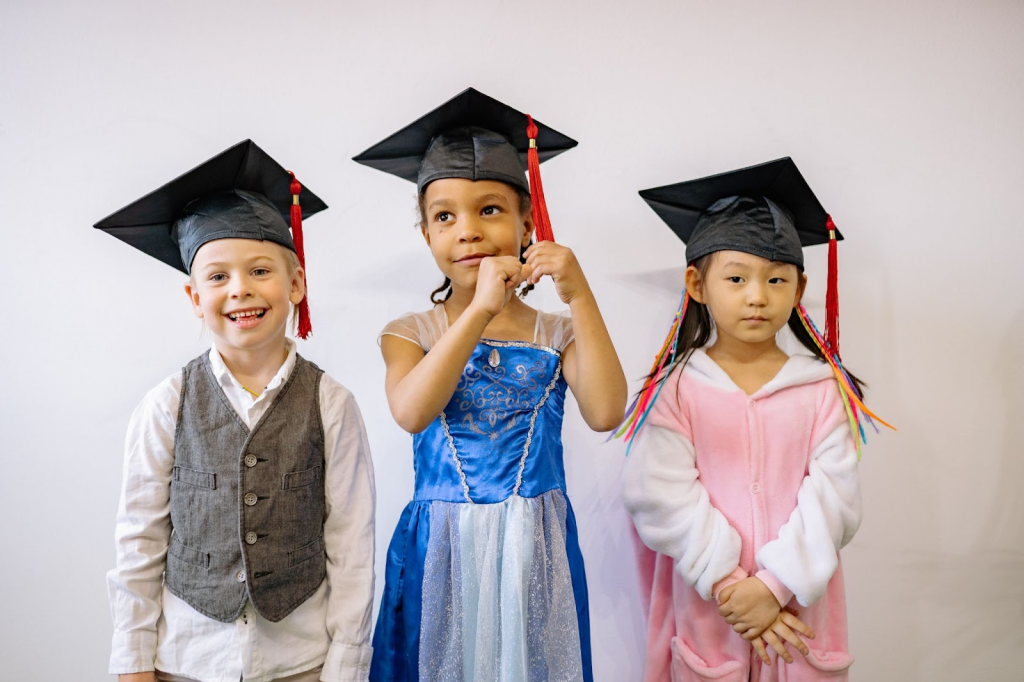 Portrait Of Children In Their Graduation Outfits