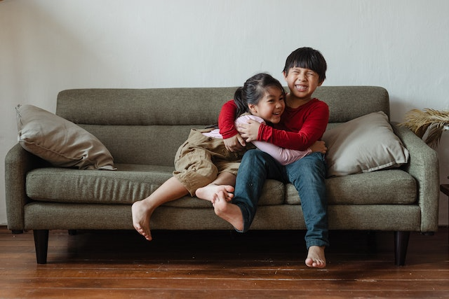 Brother and sister laughing at jokes