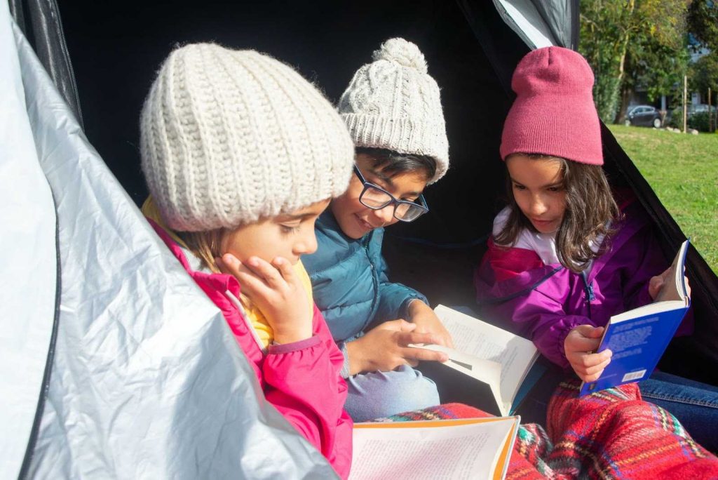 Kids Inside a Tent Reading Books