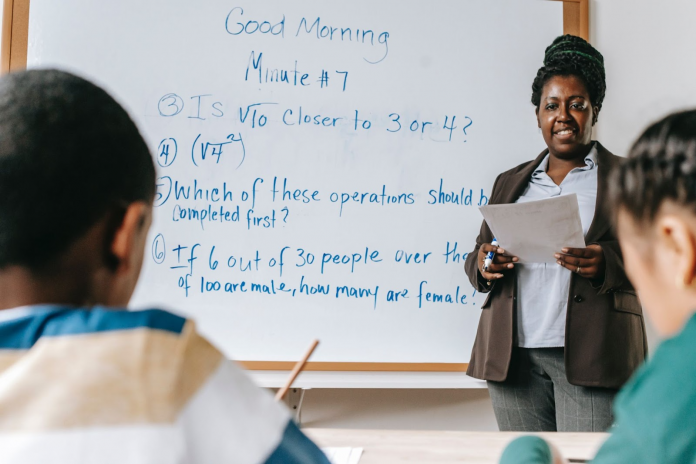 Math teacher teaching students in class