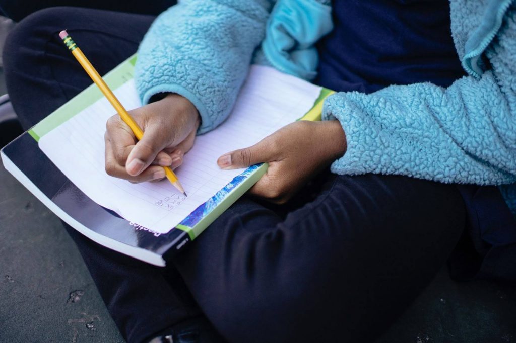 Kid writing on paper