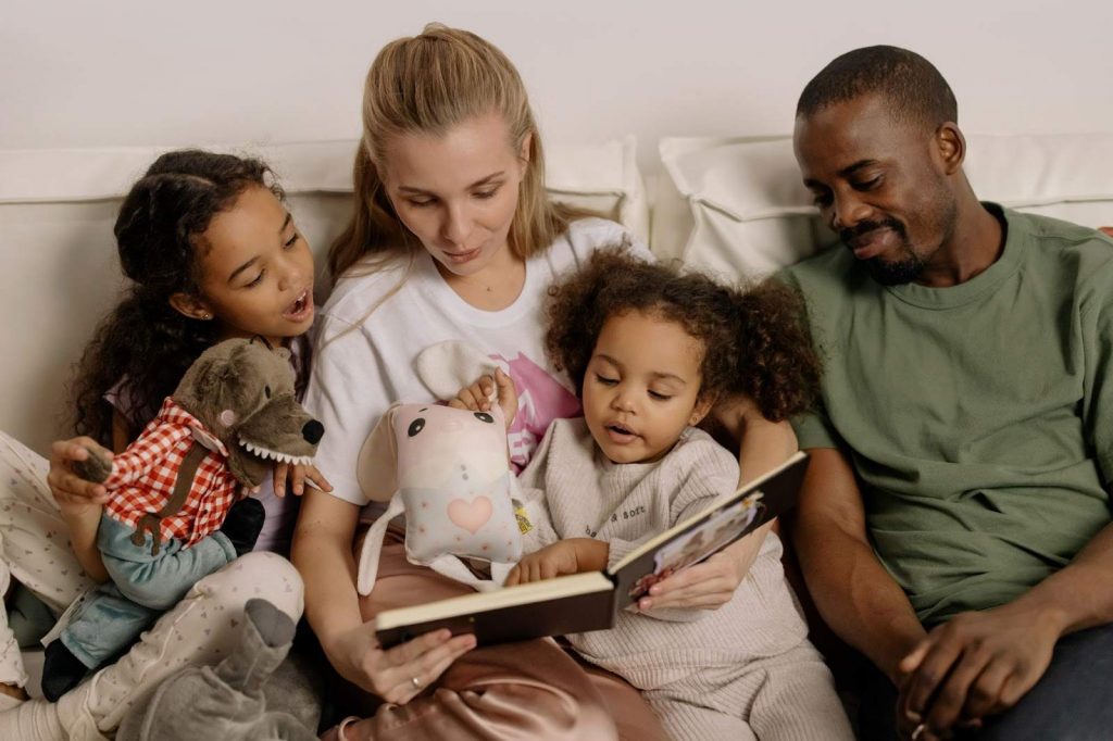 Photograph of a Family Looking at a Photo Album