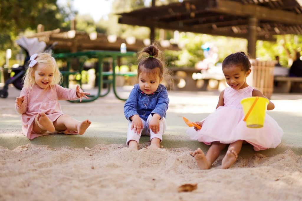 Little girls playing in sand