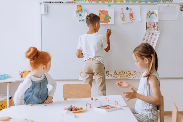 Children practicing emotional writing prompts together