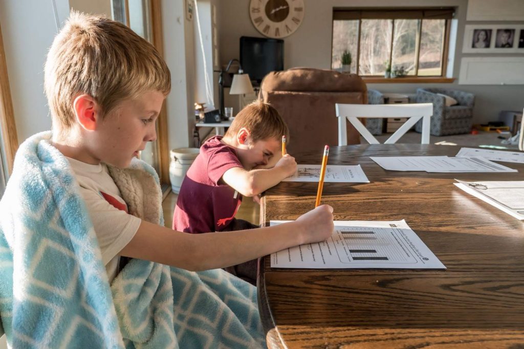 Concentrated school kids studying at home