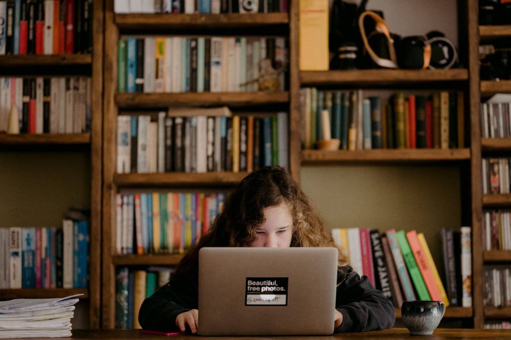Girl reading on laptop