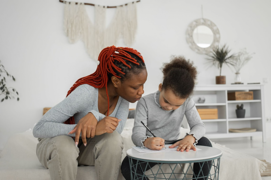 Teacher helping kid with writing