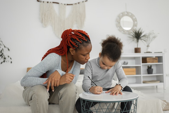 Parent guiding child on animal writing prompts