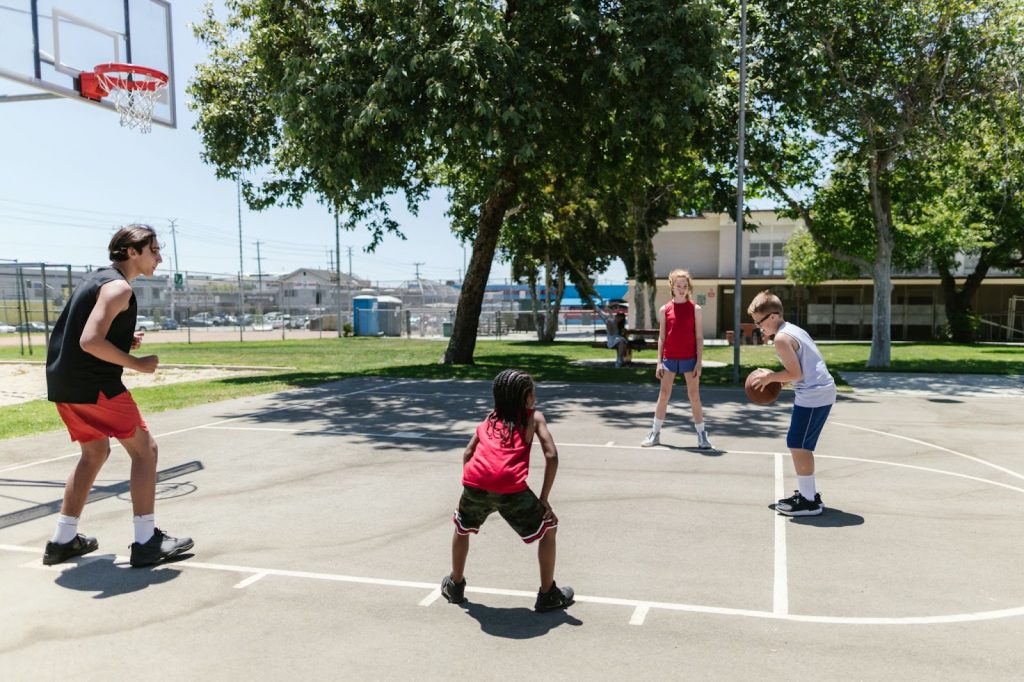 Children playing basketball on the court