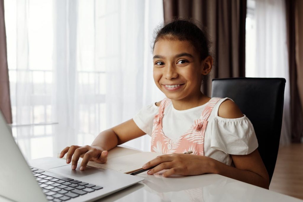 A girl feeling happy using a laptop