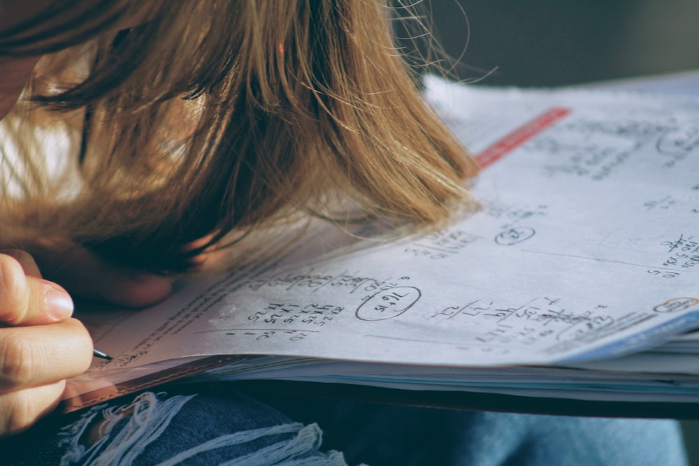 A little girl solving math worksheet