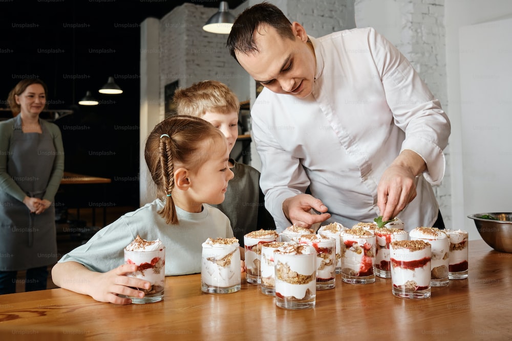 A chef helping kids with cooking