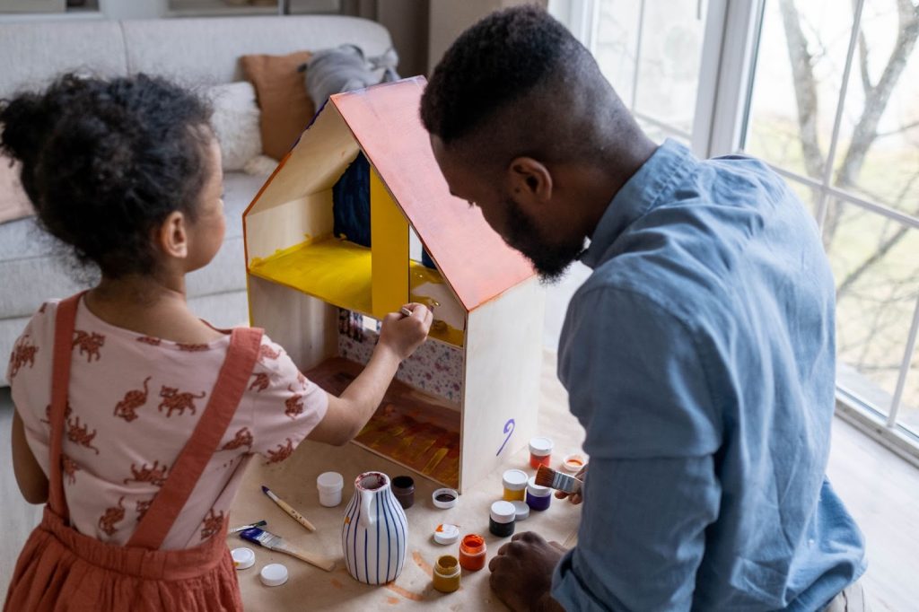 Father and daughter engaging in artwork