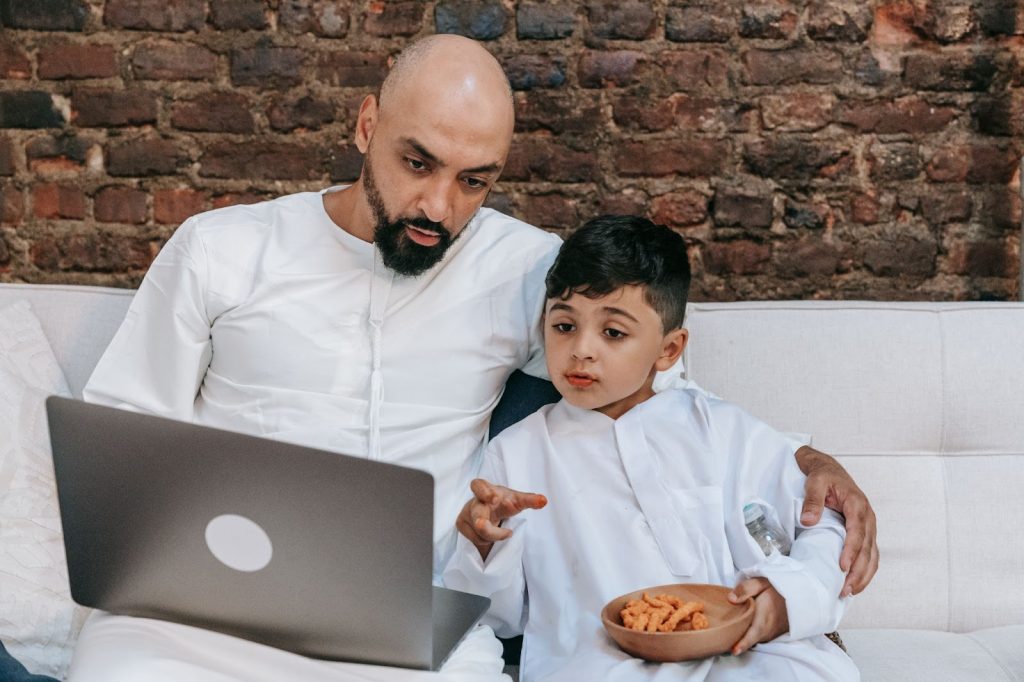 Father and son using laptop