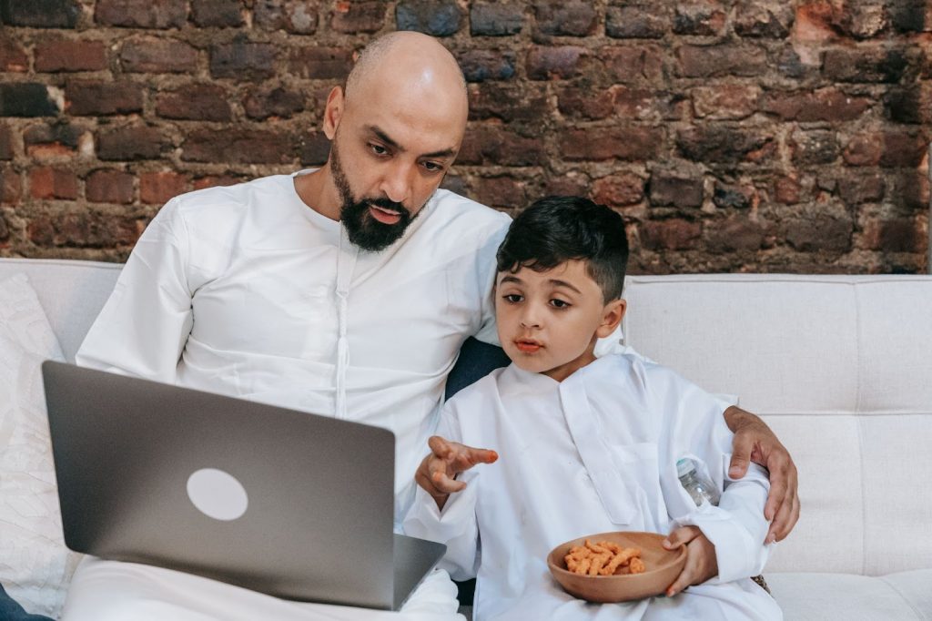 Father and son using laptop