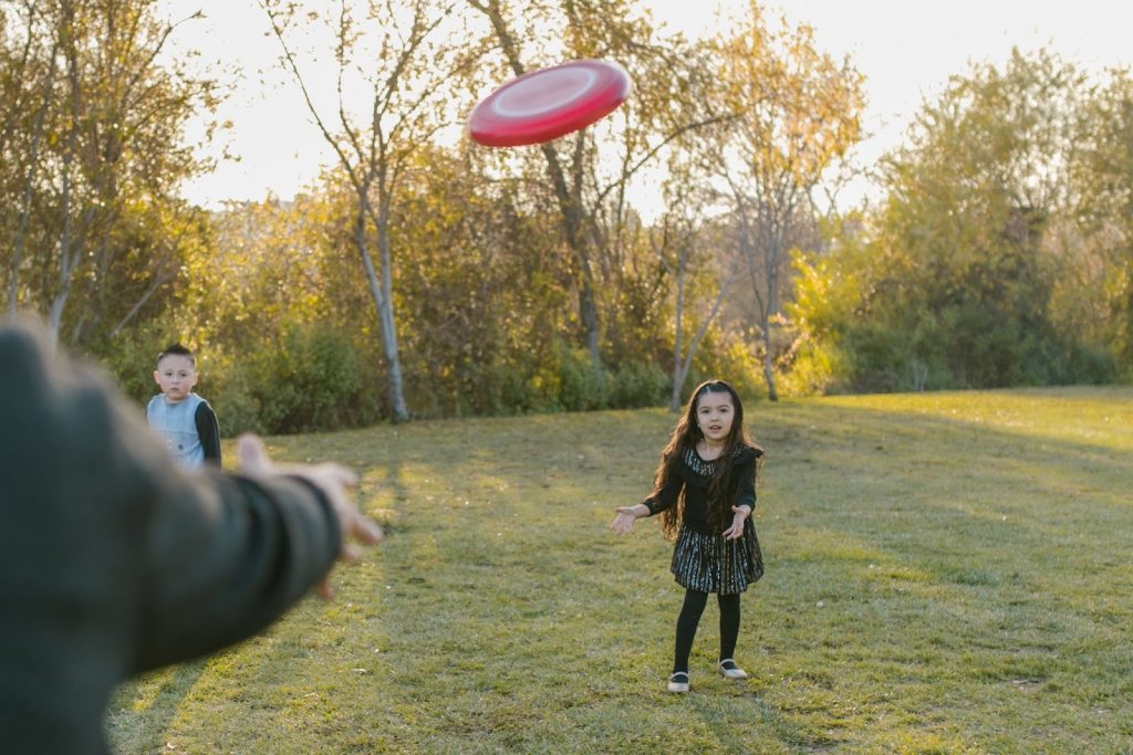 Kids in a park playing frisbee