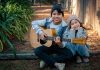 Kids sitting and playing guitar