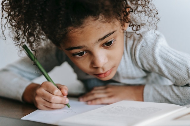 Child doing journal writing prompts