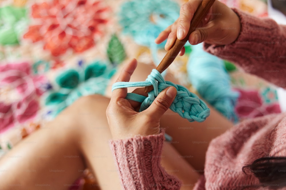 A girl knitting with a stick