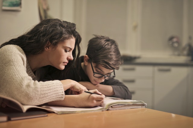 Child completing a writing prompt homework