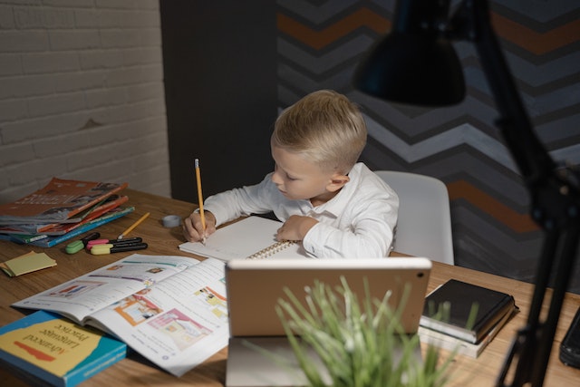 Child researching to complete writing prompt kindergarten